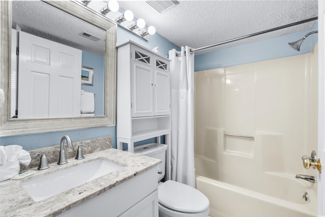 full bathroom featuring vanity, toilet, a textured ceiling, and shower / tub combo