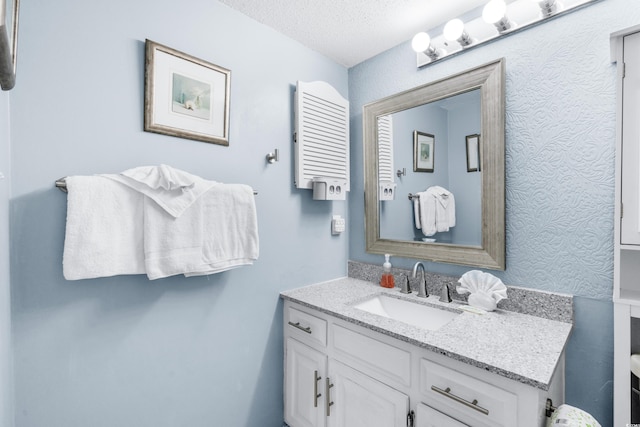 bathroom featuring vanity and a textured ceiling