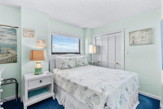 bedroom with dark carpet and a closet