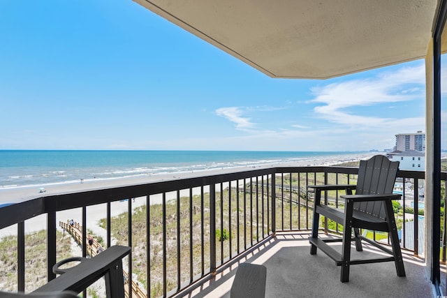 balcony featuring a water view and a view of the beach