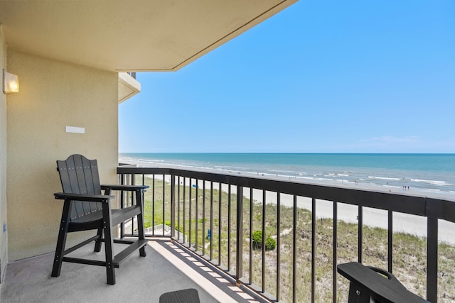 balcony featuring a water view and a view of the beach