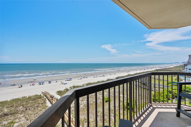 balcony featuring a beach view and a water view