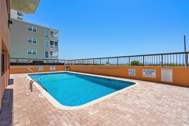 view of pool featuring a patio