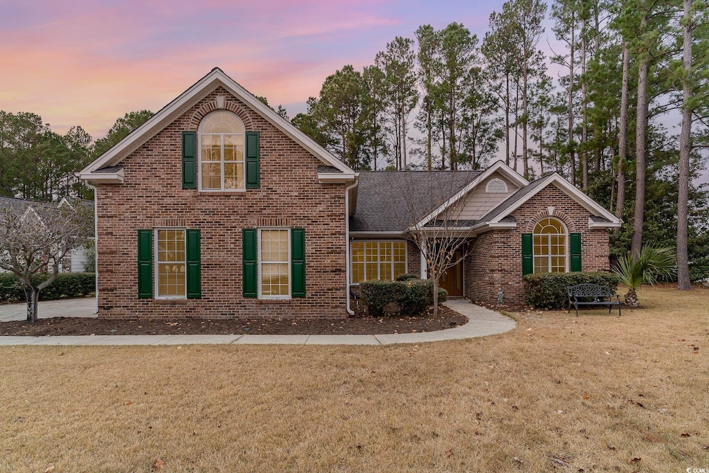 front facade with a yard