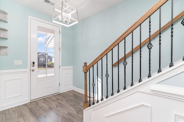 foyer with a chandelier and light hardwood / wood-style floors