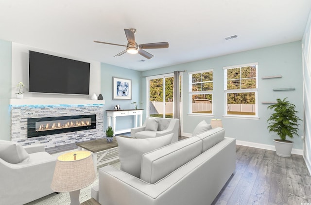 living room featuring hardwood / wood-style floors and ceiling fan