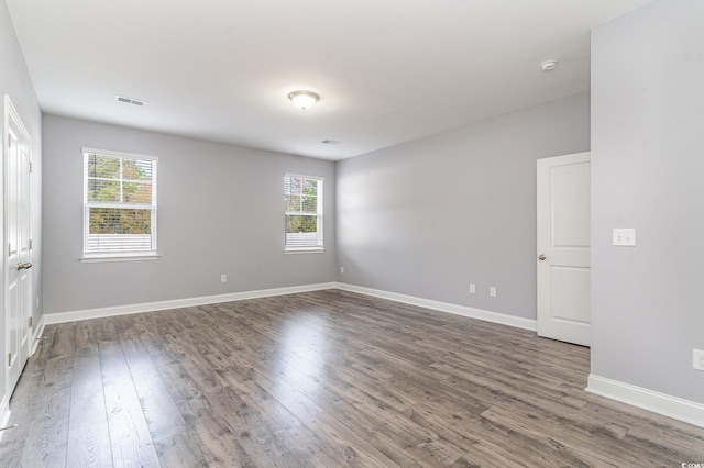 empty room featuring dark hardwood / wood-style flooring