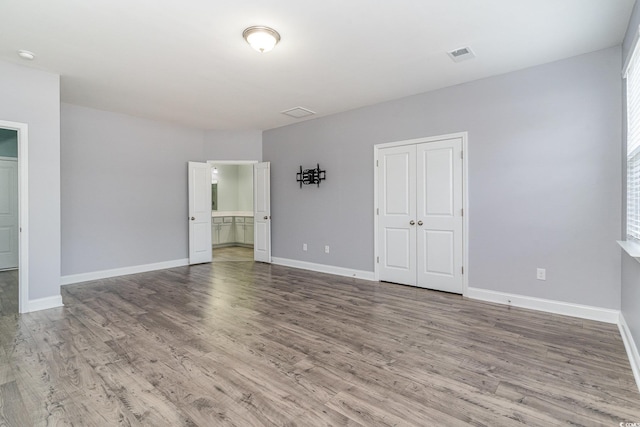 unfurnished room featuring hardwood / wood-style flooring