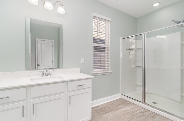 bathroom featuring vanity and a shower with shower door