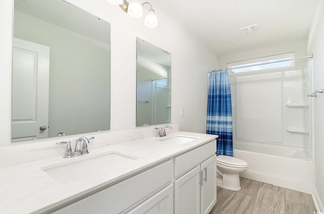 full bathroom with hardwood / wood-style floors, vanity, toilet, and shower / bath combo with shower curtain