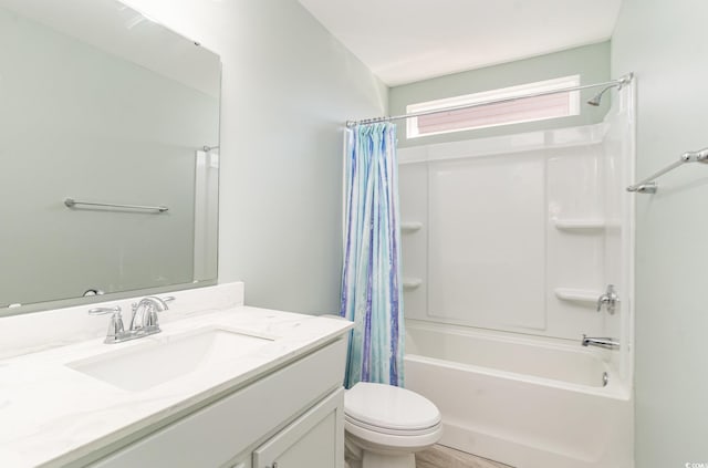 full bathroom with shower / tub combo with curtain, vanity, and toilet