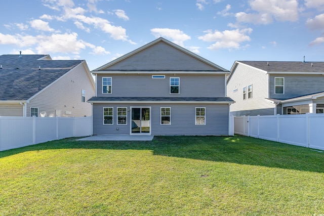 back of house featuring a patio and a lawn