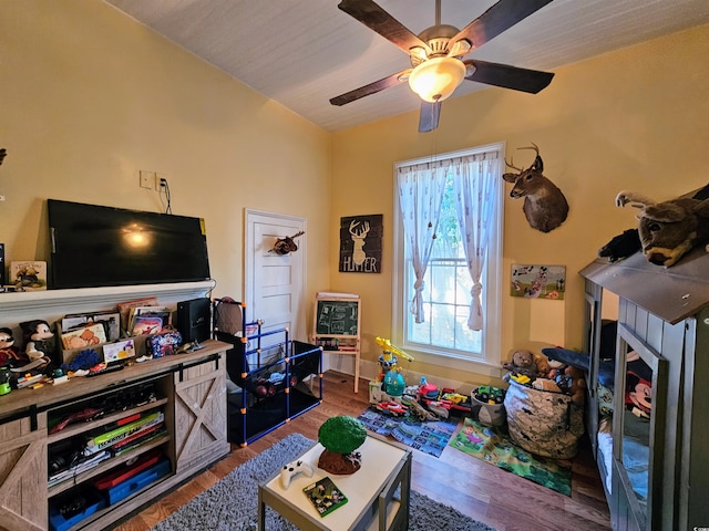 game room with ceiling fan, vaulted ceiling, and wood-type flooring