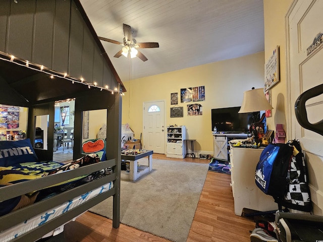 bedroom with lofted ceiling and light hardwood / wood-style flooring