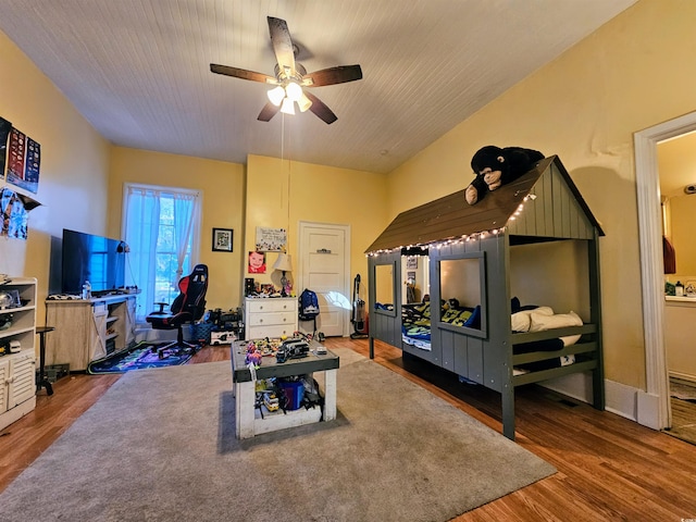 bedroom with wood-type flooring and ceiling fan