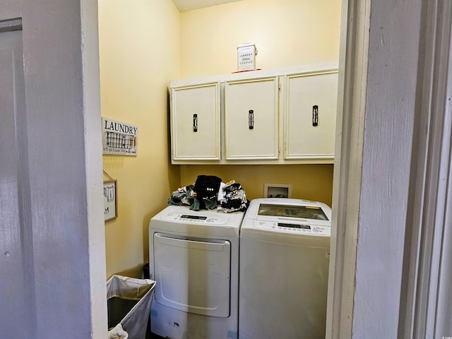 laundry area featuring cabinets and separate washer and dryer