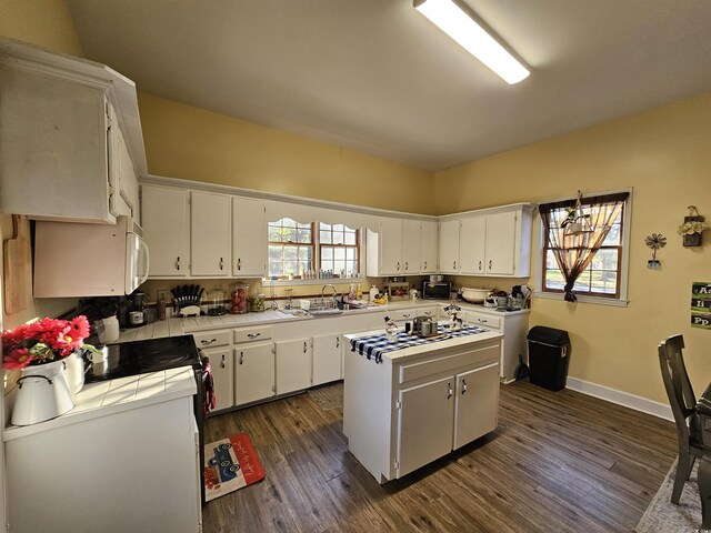 kitchen with white cabinetry, a healthy amount of sunlight, and a center island