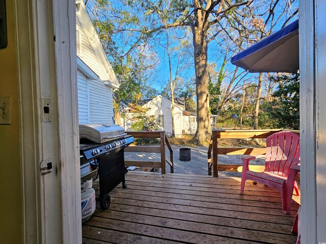 wooden terrace with area for grilling