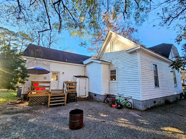 back of property featuring a wooden deck