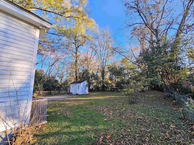 view of yard featuring cooling unit and a storage unit