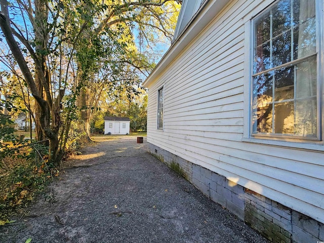 view of property exterior featuring a shed