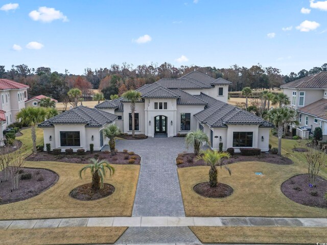 mediterranean / spanish-style house with a front lawn