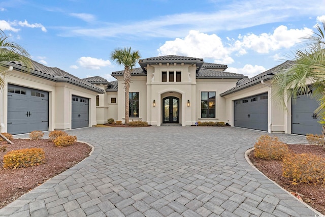 mediterranean / spanish home featuring french doors and a garage