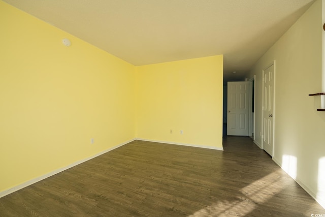 unfurnished room with dark hardwood / wood-style floors