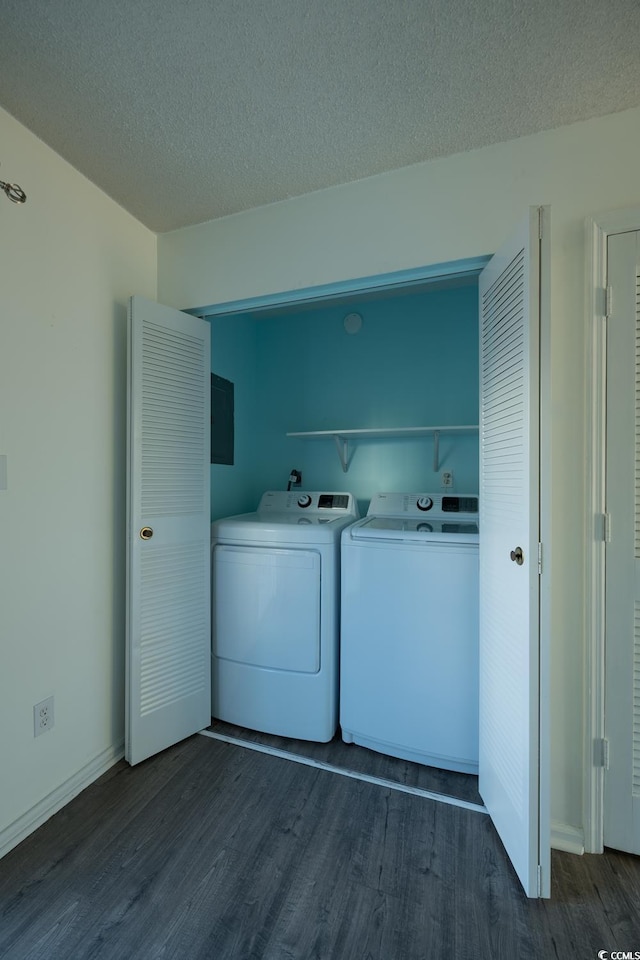 laundry room with washer and dryer, a textured ceiling, and dark hardwood / wood-style flooring