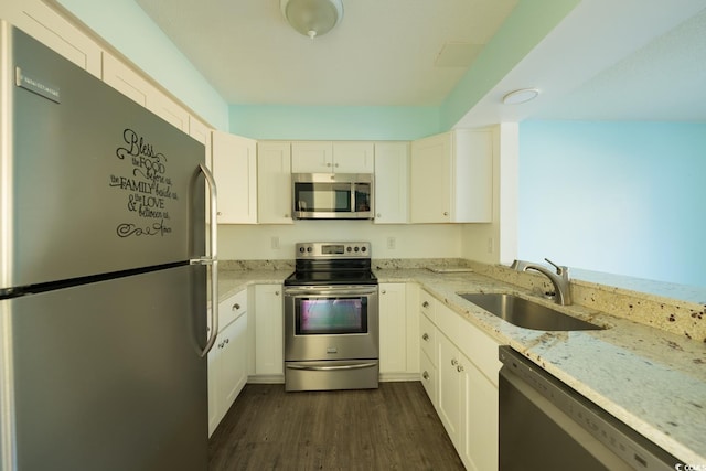 kitchen featuring white cabinets, sink, stainless steel appliances, and dark wood-type flooring