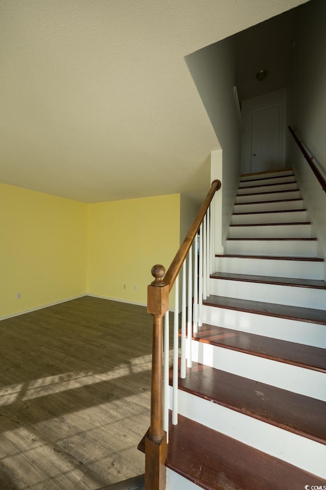 stairs featuring wood-type flooring