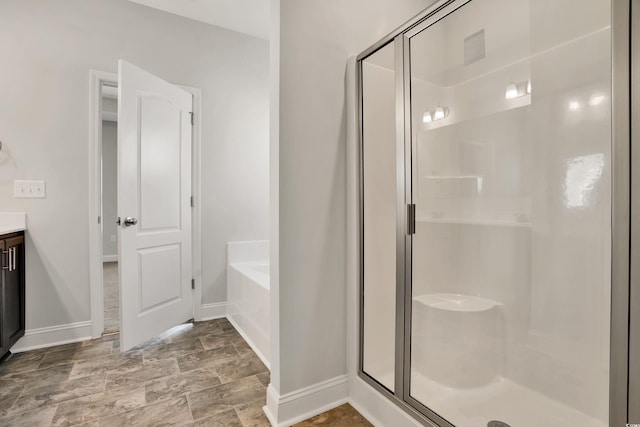 bathroom featuring vanity and plus walk in shower