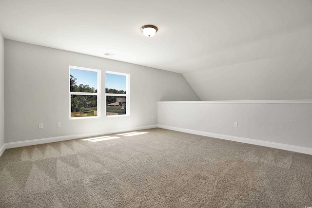 additional living space featuring carpet flooring and lofted ceiling