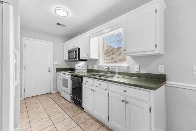 kitchen featuring white cabinetry, light tile patterned flooring, white appliances, and sink