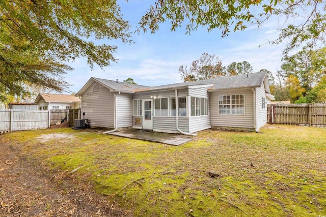 back of house with a sunroom, central air condition unit, a yard, and a patio