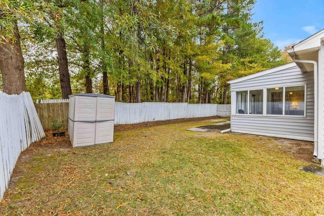 view of yard with a sunroom and a storage shed