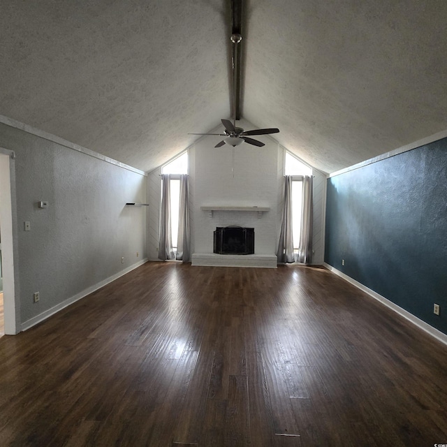 unfurnished living room featuring vaulted ceiling with beams, dark hardwood / wood-style flooring, plenty of natural light, and ceiling fan