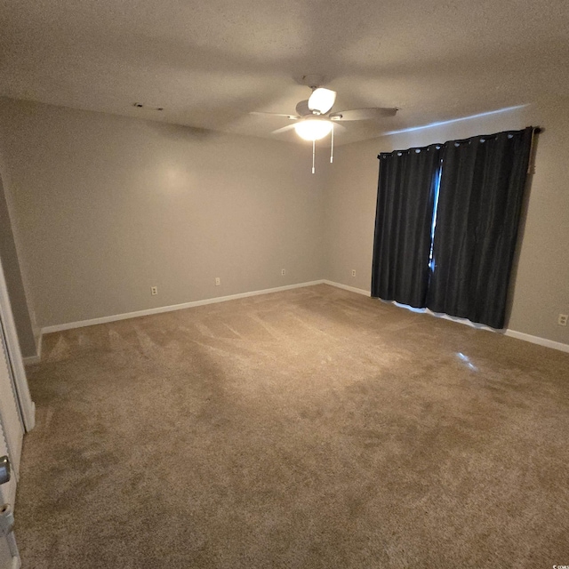 carpeted empty room featuring a textured ceiling and ceiling fan