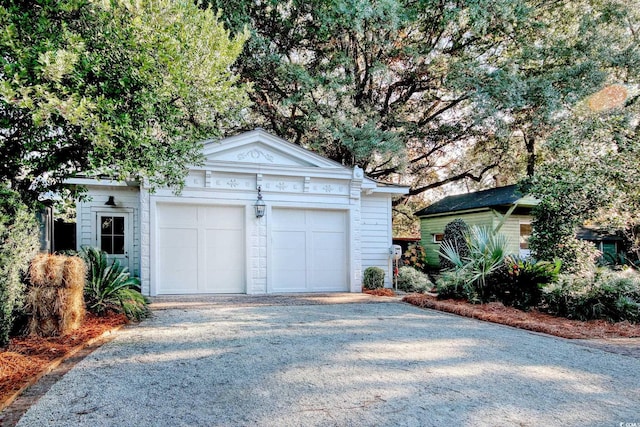 view of front facade featuring an outbuilding and a garage