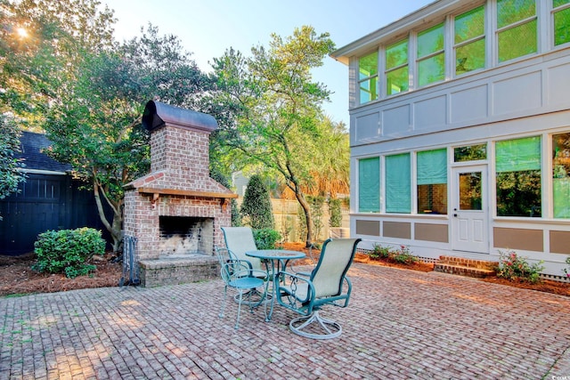 view of patio with an outdoor brick fireplace