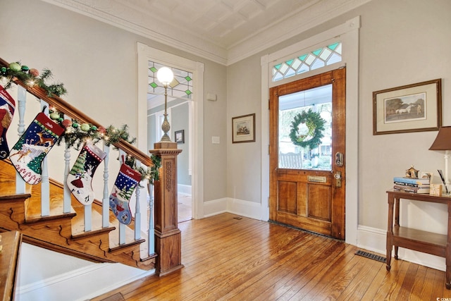 entrance foyer featuring light hardwood / wood-style floors and crown molding