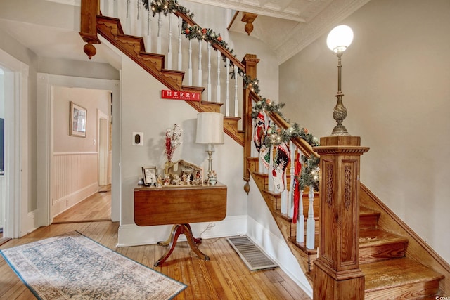 staircase with hardwood / wood-style floors