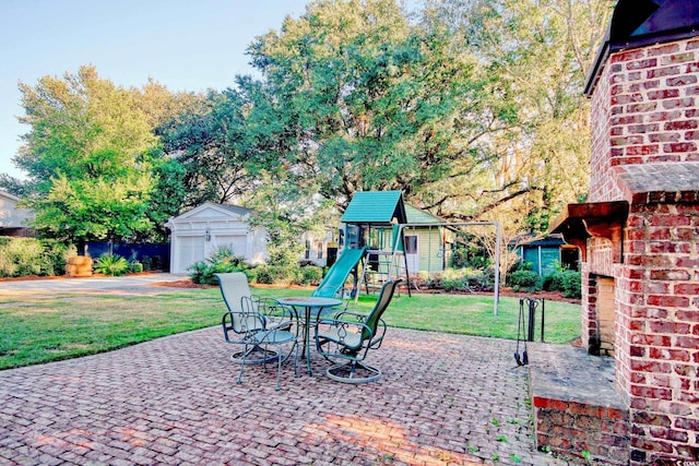 view of patio / terrace featuring a playground, an outdoor structure, and a garage