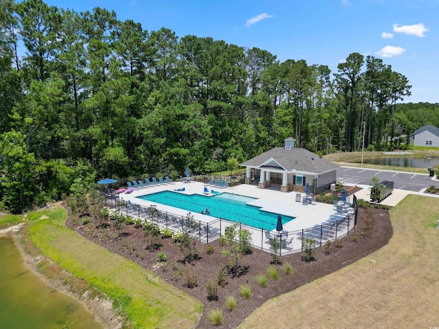 pool with a patio and fence