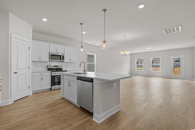 1200 NW Calabash Station Blvd, Calabash, NC 28467 - kitchen with a sink, appliances with stainless steel finishes, visible vents, a chandelier, and open floor plan