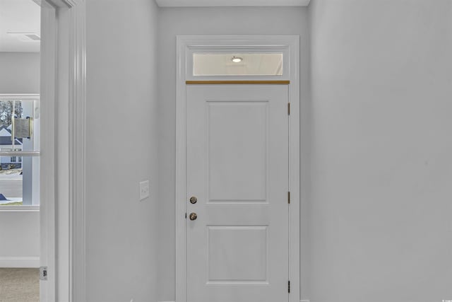 doorway with visible vents and baseboards