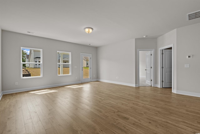 1200 NW Calabash Station Blvd, Calabash, NC 28467 - empty room with wood finished floors, visible vents, and baseboards
