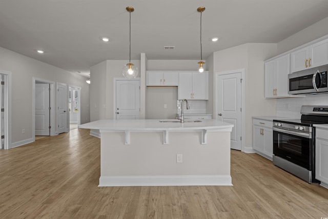 1200 NW Calabash Station Blvd, Calabash, NC 28467 - kitchen with tasteful backsplash, stainless steel appliances, light wood finished floors, and a sink