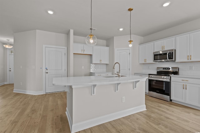 1200 NW Calabash Station Blvd, Calabash, NC 28467 - kitchen with white cabinetry, appliances with stainless steel finishes, decorative backsplash, and light countertops
