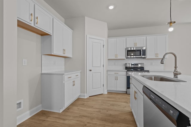 1200 NW Calabash Station Blvd, Calabash, NC 28467 - kitchen with appliances with stainless steel finishes, white cabinetry, decorative backsplash, and a sink